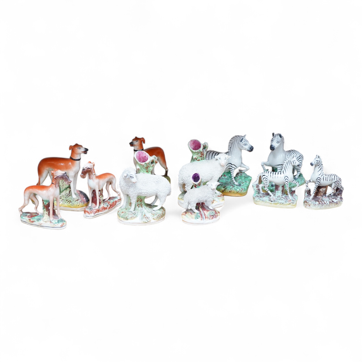 Two pairs of Victorian Staffordshire zebra models and others to include three sheep spill vases, largest 19cm high
